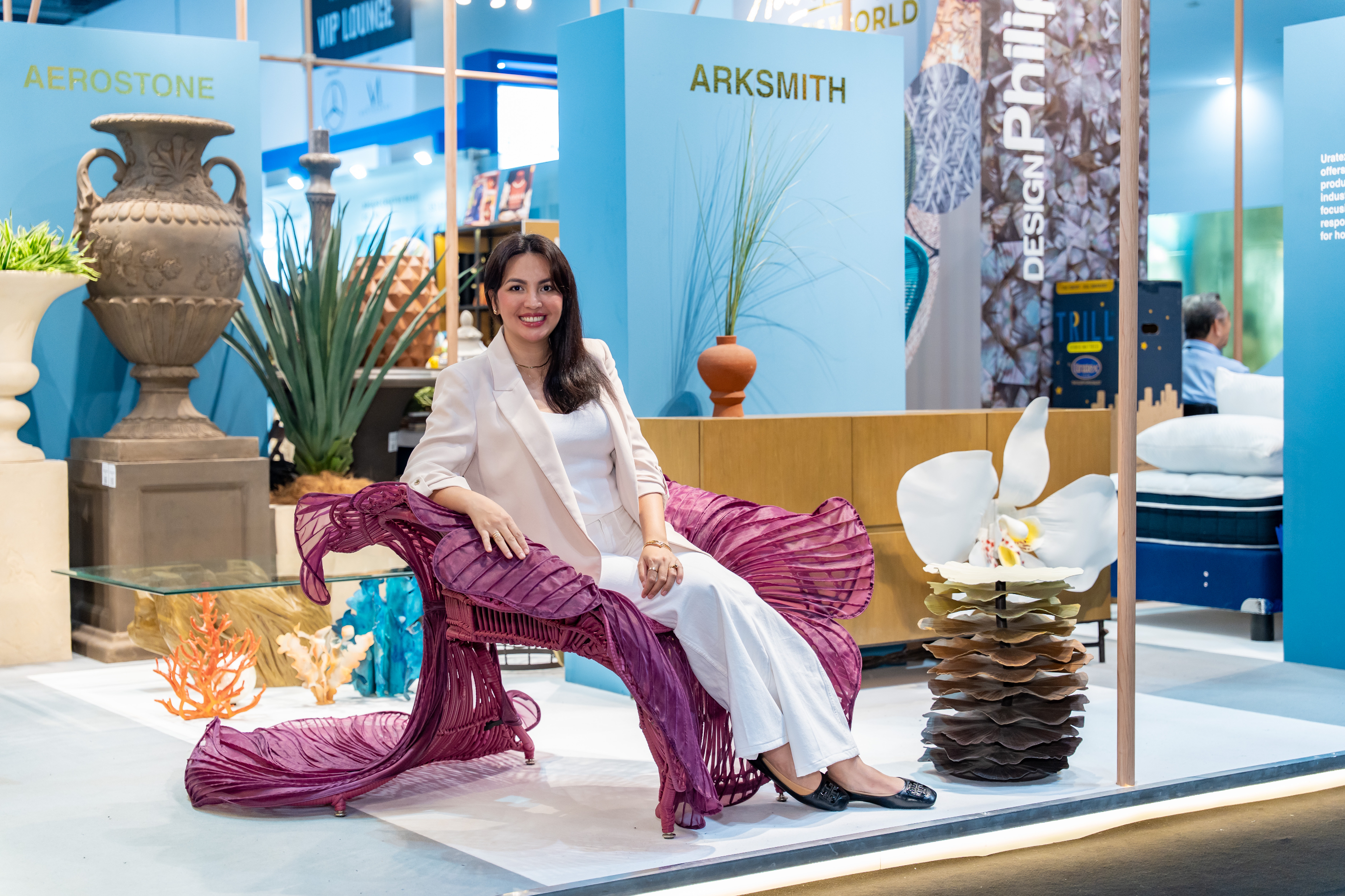 Ysla designer seated in the Rosas Lounge Chair at INDEX Dubai 2025