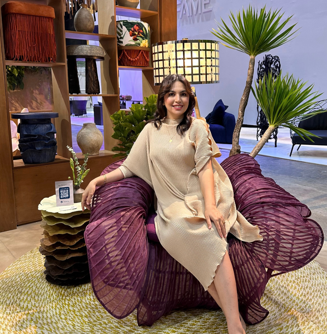 Ysla designer seated in the Rosas Lounge Chair at INDEX Dubai 2025